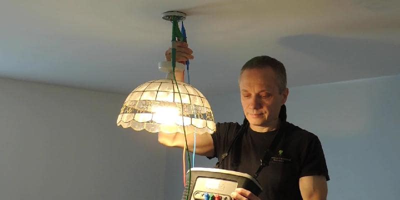 an emergency electrician tests a lamp